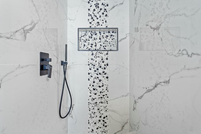 bathroom with a marble finish shower