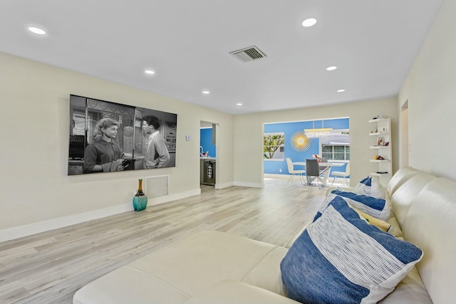 cinema room featuring baseboards, wood finished floors, visible vents, and recessed lighting