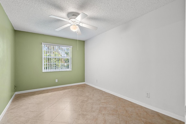 tiled empty room with baseboards, a textured ceiling, and ceiling fan