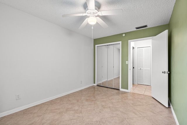 unfurnished bedroom with visible vents, baseboards, and a textured ceiling