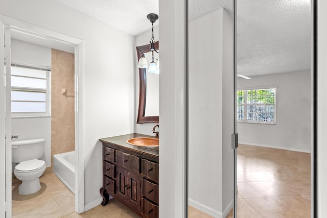 full bath with vanity, toilet, tile patterned flooring, and a textured ceiling