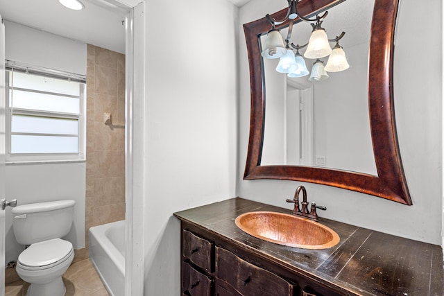 bathroom featuring toilet, vanity, and an inviting chandelier