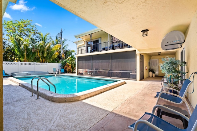 view of pool with a fenced in pool, a patio, a fenced backyard, and a sunroom