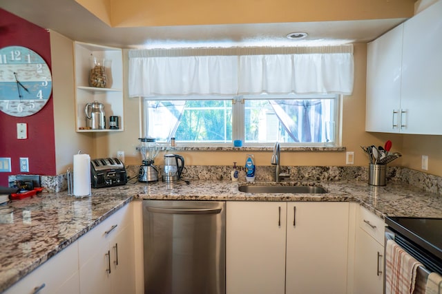kitchen featuring stainless steel dishwasher, white cabinetry, and a sink