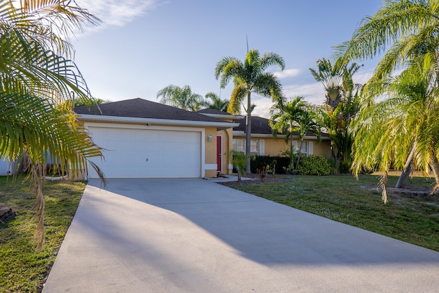 ranch-style home with a front lawn, concrete driveway, an attached garage, and stucco siding