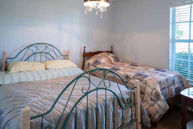 bedroom featuring a notable chandelier