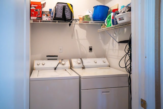 washroom featuring laundry area and washer and clothes dryer