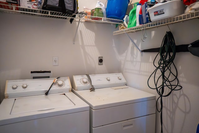 washroom with washing machine and dryer and laundry area