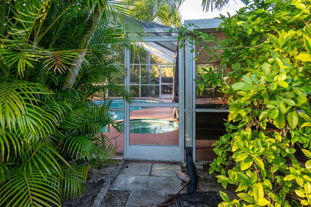 entrance to property featuring an outdoor pool