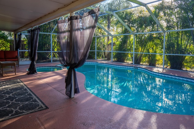 pool with glass enclosure and a patio