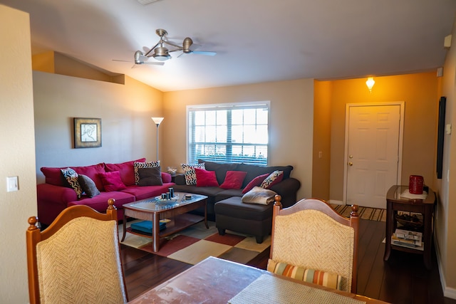 living area featuring vaulted ceiling, ceiling fan, and wood finished floors