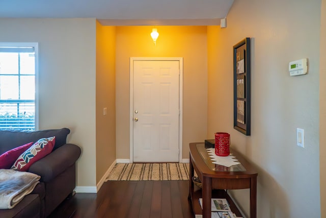 entryway featuring dark wood finished floors and baseboards