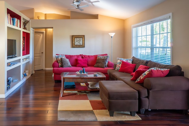 living room featuring dark wood-style floors, lofted ceiling, baseboards, and a ceiling fan