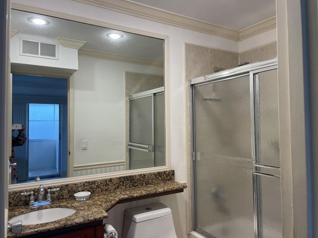138 Monaco C, Delray Beach, FL 33446 - bathroom featuring visible vents, toilet, ornamental molding, a tile shower, and vanity