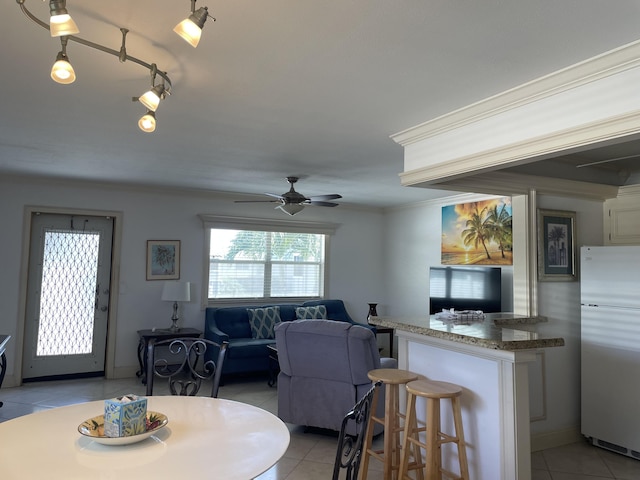 138 Monaco C, Delray Beach, FL 33446 - dining room with light tile patterned floors, a ceiling fan, and crown molding