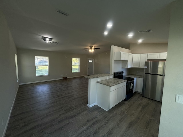 kitchen with black electric range oven, visible vents, freestanding refrigerator, open floor plan, and white cabinetry