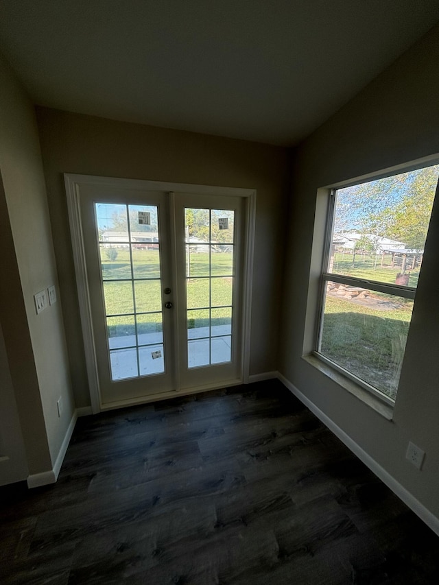 doorway with lofted ceiling, french doors, dark wood-style flooring, and baseboards