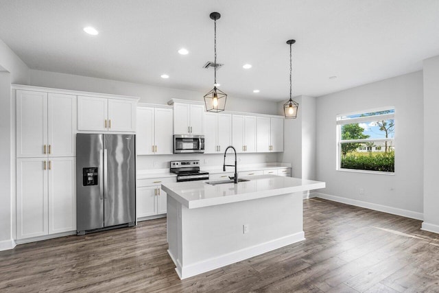 15262 Goldfinch Cir, Westlake, FL 33470 - kitchen with appliances with stainless steel finishes, a sink, a center island with sink, light countertops, and white cabinetry