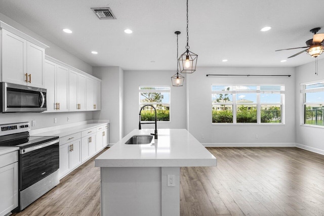 15262 Goldfinch Cir, Westlake, FL 33470 - kitchen with stainless steel appliances, a sink, light wood-style flooring, healthy amount of natural light, and recessed lighting