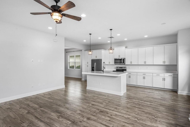 15262 Goldfinch Cir, Westlake, FL 33470 - kitchen featuring appliances with stainless steel finishes, recessed lighting, light countertops, a center island with sink, and white cabinetry