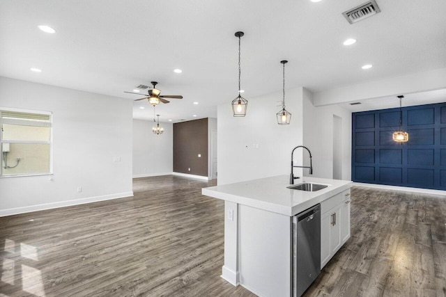 kitchen featuring white cabinets, dishwasher, an island with sink, open floor plan, and a sink