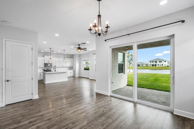 15262 Goldfinch Cir, Westlake, FL 33470 - unfurnished living room with a sink, a chandelier, dark wood-style flooring, baseboards, and recessed lighting