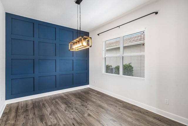 15262 Goldfinch Cir, Westlake, FL 33470 - unfurnished dining area with baseboards, dark wood-type flooring, and a chandelier