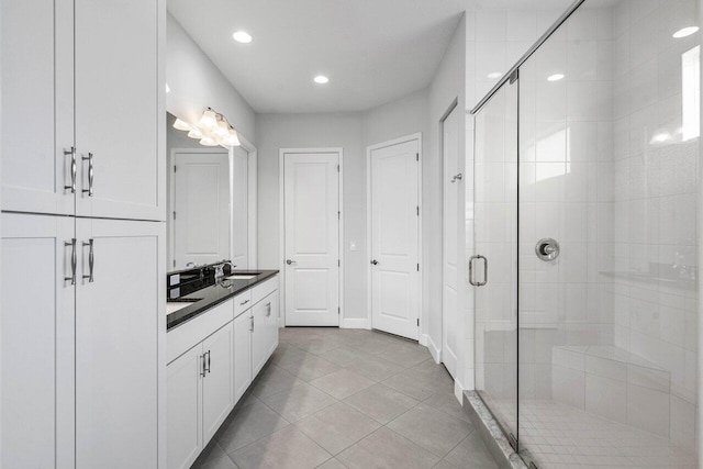 15262 Goldfinch Cir, Westlake, FL 33470 - full bath featuring a stall shower, double vanity, tile patterned floors, recessed lighting, and baseboards