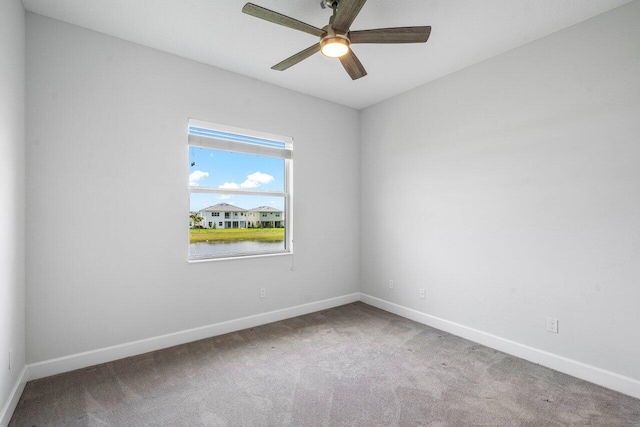 spare room featuring ceiling fan, baseboards, and carpet flooring