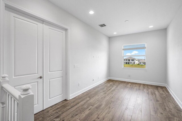 15262 Goldfinch Cir, Westlake, FL 33470 - unfurnished bedroom with wood finished floors, baseboards, recessed lighting, and a closet