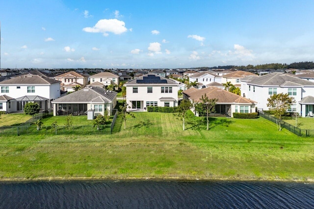 birds eye view of property featuring a water view and a residential view