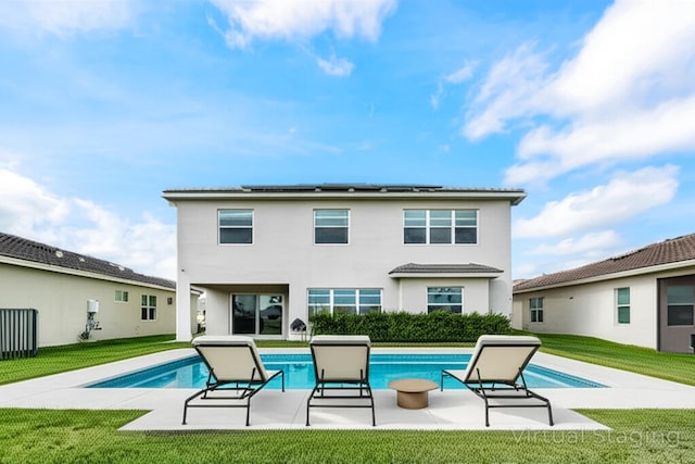 15262 Goldfinch Cir, Westlake, FL 33470 - rear view of property with a patio area, a lawn, solar panels, and stucco siding