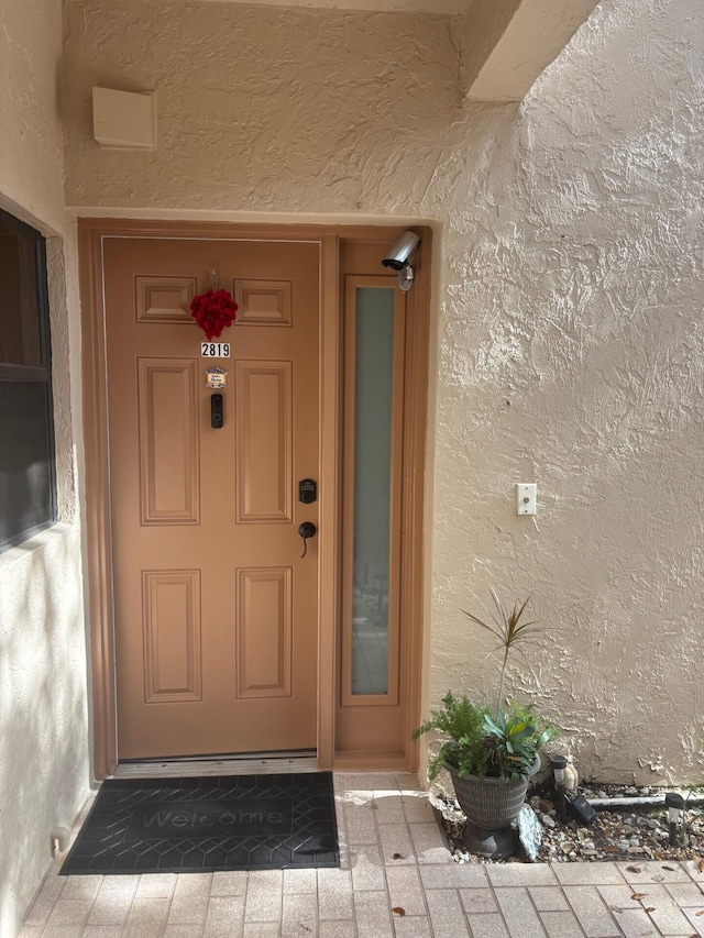 doorway to property with stucco siding