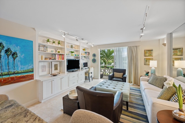 living area with light tile patterned floors and rail lighting