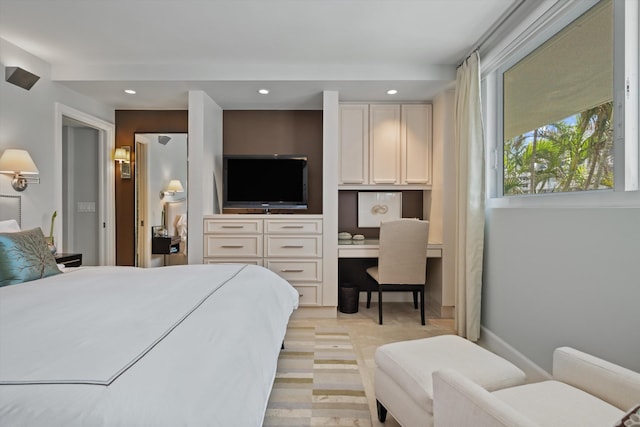 bedroom with recessed lighting, built in study area, and baseboards