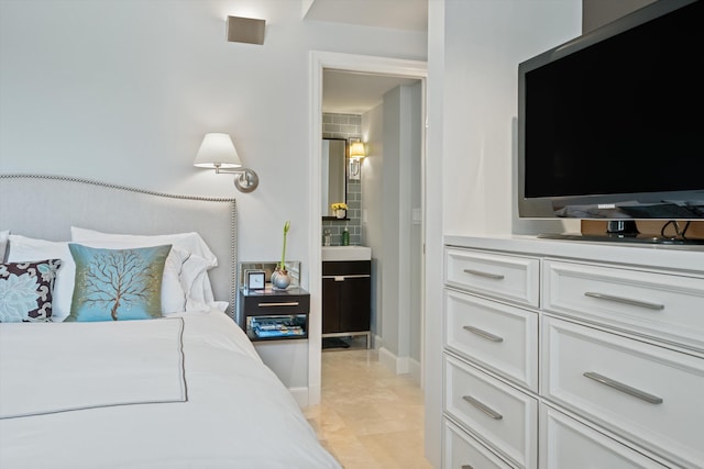 bedroom featuring a sink and baseboards