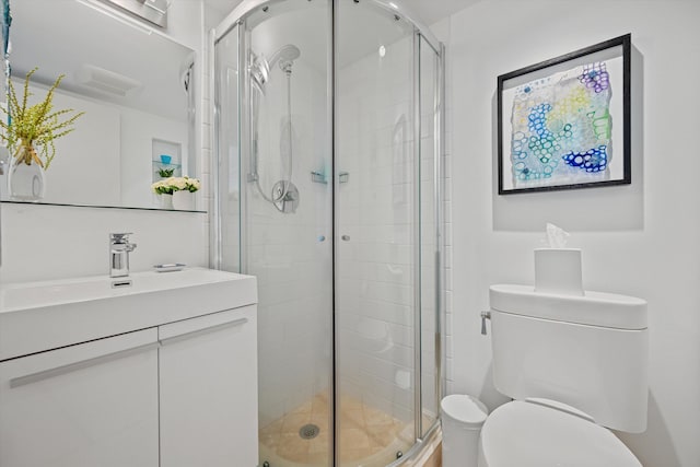 full bath with a shower stall, toilet, and vanity