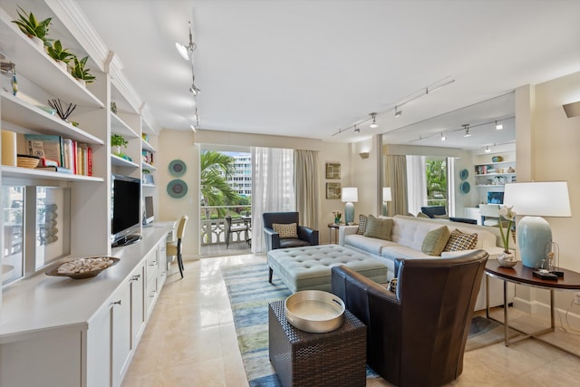 living room with plenty of natural light, rail lighting, and light tile patterned flooring