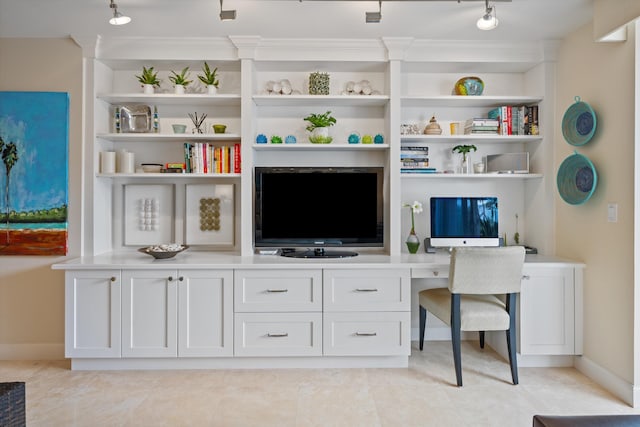 interior space with baseboards, light tile patterned floors, built in study area, and built in features