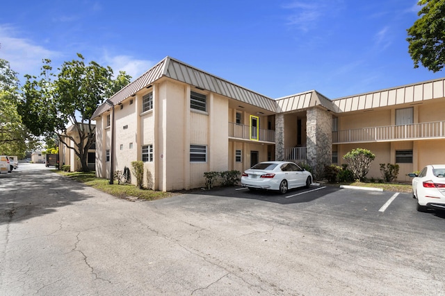 view of building exterior with uncovered parking