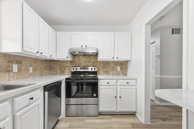 10821 N Military Trl Unit 2, Palm Beach Gardens, FL 33410 - kitchen featuring appliances with stainless steel finishes, under cabinet range hood, light countertops, and white cabinetry