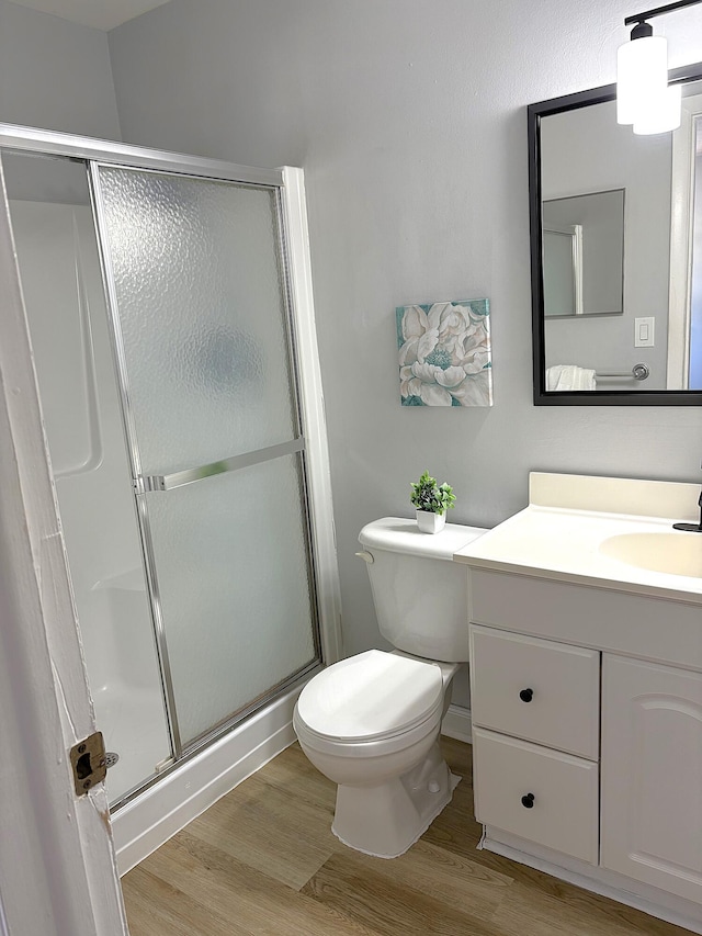 10821 N Military Trl Unit 2, Palm Beach Gardens, FL 33410 - full bathroom with a stall shower, vanity, wood finished floors, and toilet