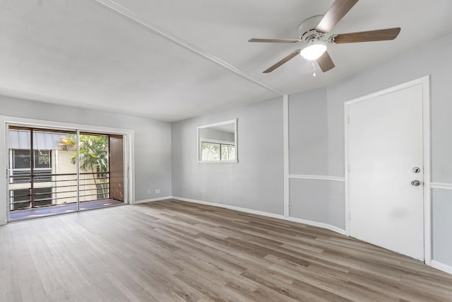 10821 N Military Trl Unit 2, Palm Beach Gardens, FL 33410 - unfurnished room with wood finished floors, plenty of natural light, ceiling fan, and baseboards