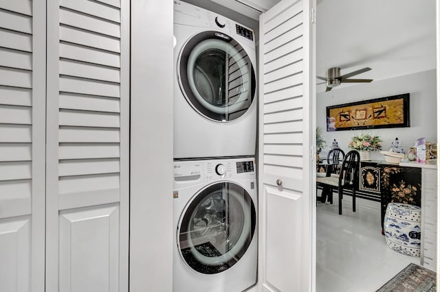 laundry area with laundry area, stacked washer / dryer, and a ceiling fan