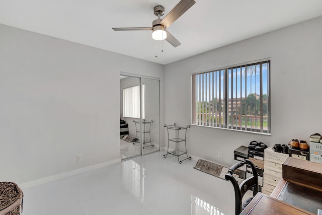 home office featuring a ceiling fan and baseboards