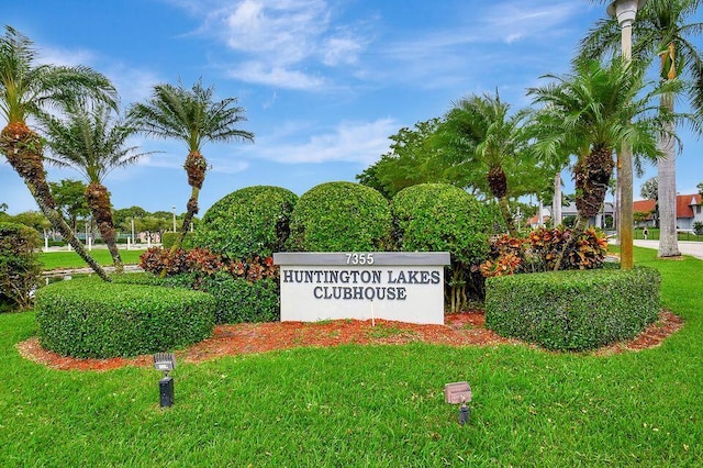 community / neighborhood sign with a lawn