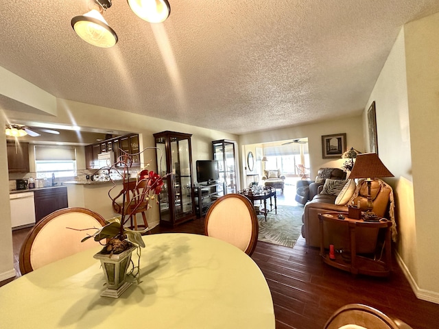 dining area featuring dark wood-type flooring, plenty of natural light, baseboards, and a ceiling fan