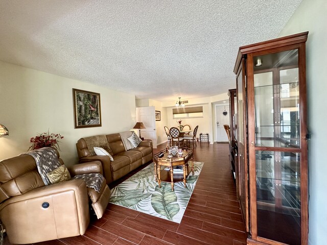 living area featuring a textured ceiling and wood finish floors