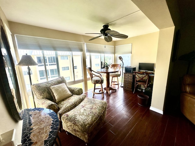 interior space featuring ceiling fan, baseboards, and dark wood finished floors