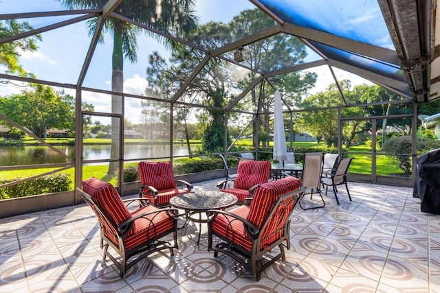 view of patio / terrace featuring a lanai and a water view